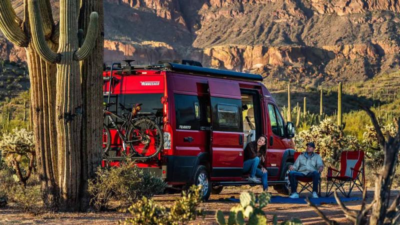 Red Winnebago campervan parked in the desert