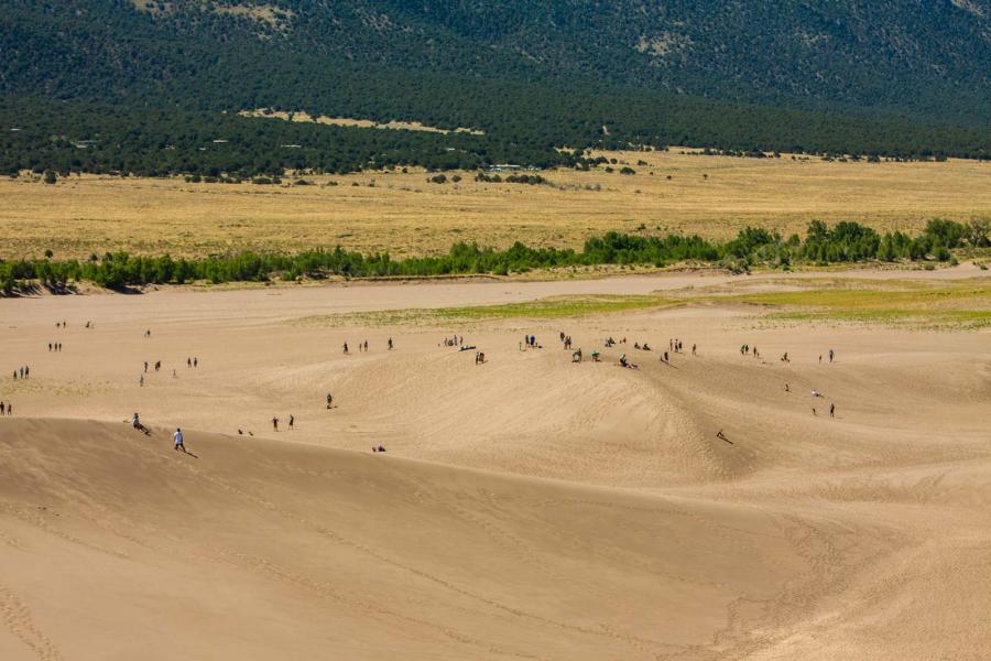 Aerial view of Great Sand Dunes with people climbing on the dunes in the distance